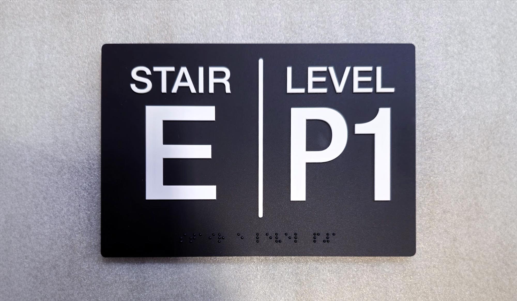 Office directional wayfinding sign with braille by Watsons Engraving and Signage in Dundas, Ontario.